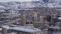 5.5K stock footage aerial video of Downtown Salt Lake City and Utah State Capitol with winter snow at sunrise Aerial Stock Footage | AX124_227