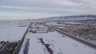 5.5K stock footage aerial video of warehouse buildings in snowy Salt Lake City at sunrise in Utah Aerial Stock Footage | AX124_234