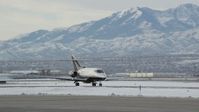 5.5K stock footage aerial video track civilian jet at Salt Lake City International Airport in winter at sunrise, Utah Aerial Stock Footage | AX124_236