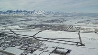 5.5K stock footage aerial video of Salt Lake City International Airport and jet on runway with winter snow in Utah Aerial Stock Footage | AX125_010