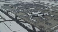 5.5K stock footage aerial video of Salt Lake City International Airport terminals with winter snow in Utah Aerial Stock Footage | AX125_014