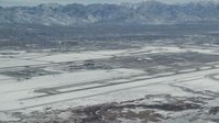 5.5K stock footage aerial video of slow approach to Salt Lake City International Airport with winter snow, Utah Aerial Stock Footage | AX125_322