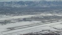 5.5K stock footage aerial video slow approach to SLC International Airport with white winter snow, Utah Aerial Stock Footage | AX125_323