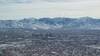 5.5K stock footage aerial video of Downtown Salt Lake City, Utah, with winter snow Aerial Stock Footage | AX125_336