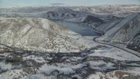 5.5K stock footage aerial video approach Deer Creek Reservoir from a snowy, hilly valley in winter, Utah Aerial Stock Footage | AX126_303