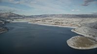 5.5K stock footage aerial video approach snowy Heber City from icy Deer Creek Reservoir in winter, Utah Aerial Stock Footage | AX126_316