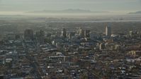 5.5K stock footage aerial video of Downtown Salt Lake City with winter snow seen from east of the city at sunset, Utah Aerial Stock Footage | AX127_084
