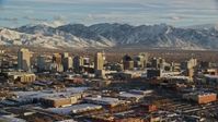 5.5K stock footage aerial video orbit west side of Downtown Salt Lake City with winter snow at sunset, Utah Aerial Stock Footage | AX127_094