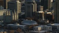 5.5K stock footage aerial video orbit Salt Lake Temple, Tabernacle and Assembly Hall at sunset with winter snow, Salt Lake City, Utah Aerial Stock Footage | AX127_119