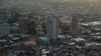 5.5K stock footage aerial video orbit tall buildings by Salt Lake Temple in downtown at sunset with winter snow, Utah Aerial Stock Footage | AX127_124