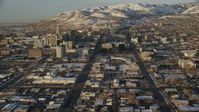 5.5K stock footage video of reverse view of wide streets through Downtown Salt Lake City at sunset in winter, Utah Aerial Stock Footage | AX127_131