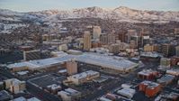 5.5K stock footage aerial video of Salt Palace and Downtown Salt Lake City buildings with winter snow at sunset, Utah Aerial Stock Footage | AX127_160
