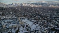 5.5K stock footage aerial video orbit Utah State Capitol building to reveal Downtown Salt Lake City at sunset with winter snow Aerial Stock Footage | AX127_163