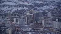 5.5K stock footage aerial video of Downtown SLC buildings with winter snow on rooftops at twilight, Utah Aerial Stock Footage | AX128_032