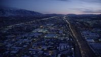 5.5K stock footage aerial video approach shopping center by I-15 with heavy traffic in winter at twilight, Salt Lake City, Utah Aerial Stock Footage | AX128_068