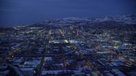 5.5K stock footage aerial video of flying north to approach Downtown Salt Lake City at Night in winter, Utah Aerial Stock Footage | AX128_069