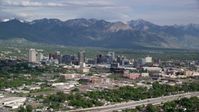 5.5K stock footage aerial video of flying by the city, Wasatch Range in the distance, Downtown Salt Lake City, Utah Aerial Stock Footage | AX129_004