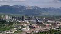 5.5K stock footage aerial video of flying by city buildings, Wasatch Range in the distance, Downtown Salt Lake City, Utah Aerial Stock Footage | AX129_005