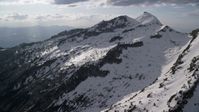 5.5K stock footage aerial video of flying by Lone Peak, snow-covered Wasatch Range, Utah Aerial Stock Footage | AX129_120
