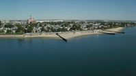 5.5K stock footage aerial video flying by coastal community, beach, breakwaters, South Boston, Massachusetts Aerial Stock Footage | AX142_209