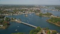 6k stock footage aerial video flying over a small bridge toward a coastal town in autumn, Portsmouth, New Hampshire Aerial Stock Footage | AX147_173
