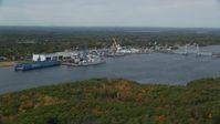 6k stock footage aerial video flying by waterfront General Dynamics Bath Iron Works, autumn, Bath, Maine Aerial Stock Footage | AX147_411