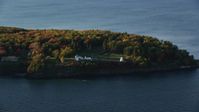 5.5K stock footage aerial video flying by Fort Point Light, among fall foliage, autumn, Stockton Springs, Maine Aerial Stock Footage | AX149_088