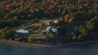 5.5K stock footage aerial video flying by French's Point in front of colorful forest, autumn, Stockton Springs, Maine Aerial Stock Footage | AX149_090