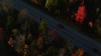 5.5K stock footage aerial video tracking car on road through forest in autumn, Stockton Springs, Maine, sunset Aerial Stock Footage | AX149_135