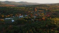 5.5K stock footage aerial video approaching small rural town, colorful forest in autumn, Searsmont, Maine, sunset Aerial Stock Footage | AX149_175