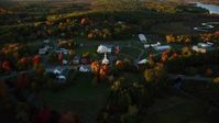 5.5K stock footage aerial video orbiting a small rural town, colorful trees in autumn, Searsmont, Maine, sunset Aerial Stock Footage | AX149_179