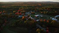 5.5K stock footage aerial video orbiting a small rural town and trees in autumn, Searsmont, Maine, sunset Aerial Stock Footage | AX149_180