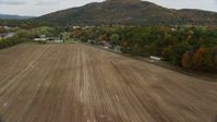 5.5K stock footage aerial video approaching tractor, farmland, Hospital Road, autumn, Woodsville, New Hampshire Aerial Stock Footage | AX150_292