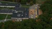 5.5K stock footage aerial video orbiting Hooksett Memorial School, revealing buses, autumn, Hooksett, New Hampshire Aerial Stock Footage | AX152_026