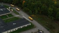 5.5K stock footage aerial video orbiting Hooksett Memorial School, tracking buses leaving, autumn, Hooksett, New Hampshire Aerial Stock Footage | AX152_028