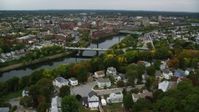 5.5K stock footage aerial video flying over town toward bridge spanning a river, approaching a hospital, Lowell, Massachusetts Aerial Stock Footage | AX152_127