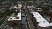 5.5K stock footage aerial video flying over factory buildings along a canal, autumn, Lowell, Massachusetts Aerial Stock Footage | AX152_137