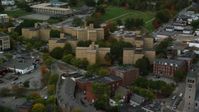 5.5K stock footage aerial video flying by urban apartment buildings among partial fall foliage, Lowell, Massachusetts Aerial Stock Footage | AX152_139