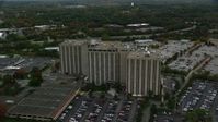 5.5K stock footage aerial video orbiting away from an office building and parking lots, autumn, Lowell, Massachusetts Aerial Stock Footage | AX152_145