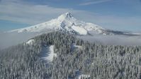 5.5K stock footage aerial video approaching a mountain ridge and snowy evergreens near Mount Hood, Cascade Range, Oregon Aerial Stock Footage | AX154_114