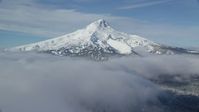 5.5K stock footage aerial video of snow-capped peak surrounded by low clouds, Mount Hood, Cascade Range, Oregon Aerial Stock Footage | AX154_116