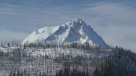 5.5K stock footage aerial video of a summit of a mountain peak behind a ridge with dead evergreens, Mount Hood, Cascade Range, Oregon Aerial Stock Footage | AX154_123