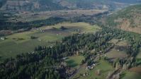 5.5K stock footage aerial video flying by rural farms and fields in Parkdale, Oregon Aerial Stock Footage | AX154_143