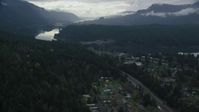 5.5K stock footage aerial video flying over evergreens by Interstate 84 to approach the Bridge of the Gods, Cascade Locks, Oregon in Columbia River Gorge Aerial Stock Footage | AX154_170