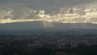 5.5K stock footage aerial video of Cascade Range and godrays shining from clouds seen from suburban neighborhood, Beaverton, Oregon Aerial Stock Footage | AX155_007