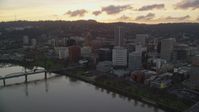 5.5K stock footage aerial video flying by the Hawthorne Bridge, the waterfront park and Downtown Portland at twilight in Oregon Aerial Stock Footage | AX155_174