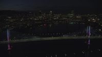 5.5K stock footage aerial video of Tilikum Crossing as it changes colors and Marquam Bridge, with Downtown Portland skyline in the distance, Oregon, night Aerial Stock Footage | AX155_325