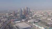 4K stock footage aerial video tilting from heavy rush hour traffic on I-110 to reveal Staples Center, Ritz-Carlton and Downtown Los Angeles skyscrapers in California Aerial Stock Footage | AX43_034