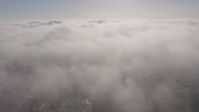 4K stock footage aerial video flying by sunlit marine layer clouds, Los Angeles, California Aerial Stock Footage | AX43_054
