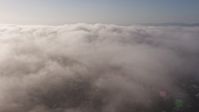4K stock footage aerial video panning across marine layer clouds over Los Angeles, California Aerial Stock Footage | AX43_057